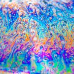Abstract, colorful liquid swirls in blue, orange, purple—rainbow-like patterns across the image.